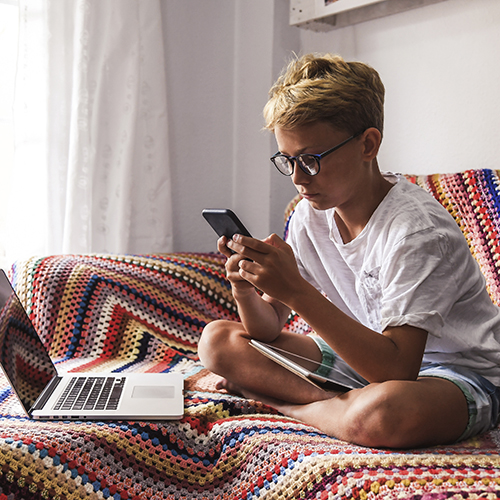 Beautiful blonde teen reading new trend stories online on smartp
